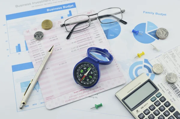 Compass, pen, glasses and calculator on saving book, investment — Stock Photo, Image