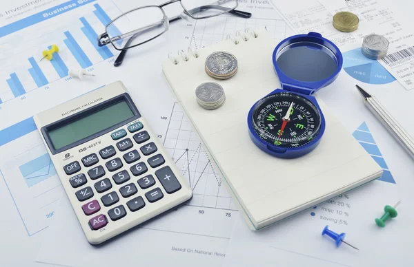 Compass, pen, glasses and calculator on paper graph, investment — Stock Photo, Image