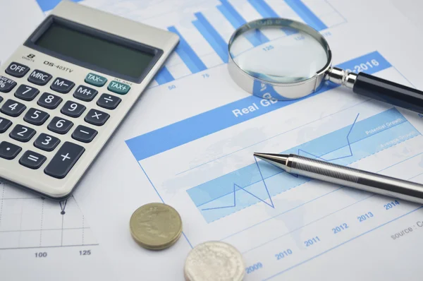 Pen, magnifying glass and coin on financial chart and graph, acc — Stock Photo, Image
