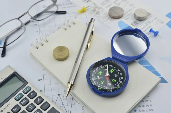 Compass, pen and coin on notebook, accounting background — Stock Photo, Image