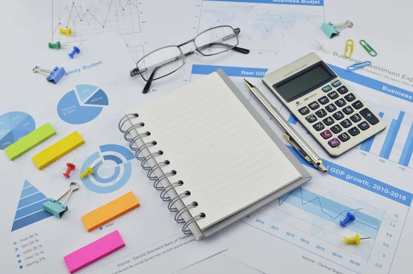 Книга, ручка, калькулятор, очки, банкноты и финансовый график — стоковое фото