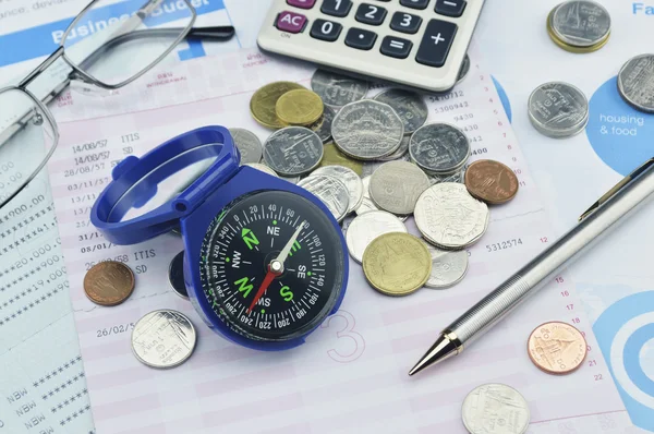 Blue compass, pen, glasses and coin on graph paper, saving conce — Stock Photo, Image