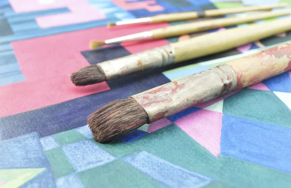 Old paintbrush on paint image — Stock Photo, Image