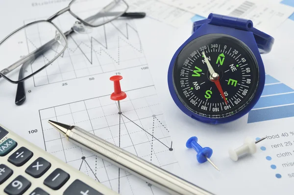 Blue compass, calculator, pen and glasses on graph paper, succes — Stock Photo, Image