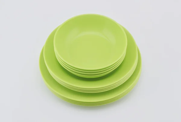 Stack of green plastic plate and dish isolated on white — Stock Photo, Image