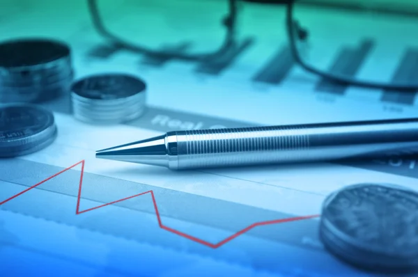 Pen, gasses and coin on financial chart and graph — Stock Photo, Image