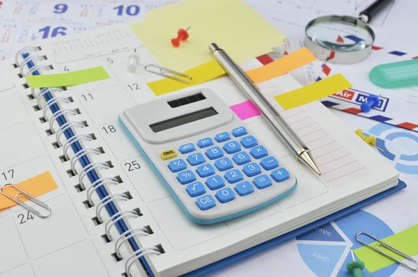 Calculator with colorful post It notes on business diary page — Stock Photo, Image