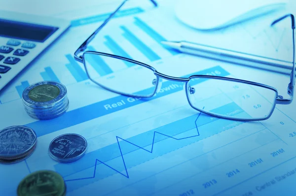 Glasses, pen and coin on growth financial graph, accounting back — Stock Photo, Image