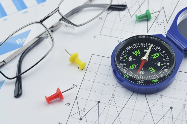 Blue compass, pin and glasses on graph paper, success concept — Stock Photo, Image