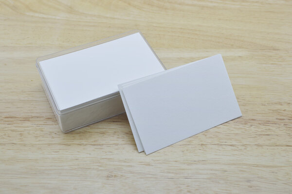 Blank business card with box on wooden table