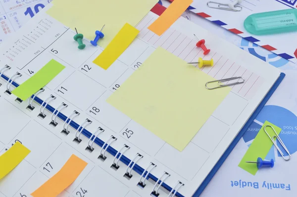 Colorful sticky notes and pin on diary page — Stock Photo, Image