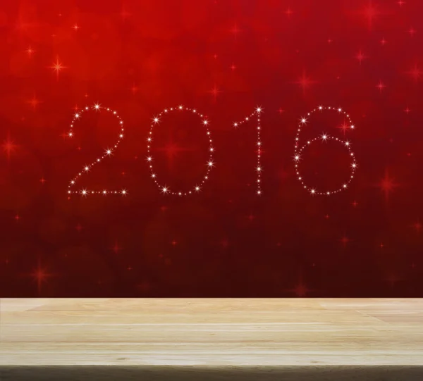 2016 from beautiful bright stars over empty wooden table and red — Stock Photo, Image