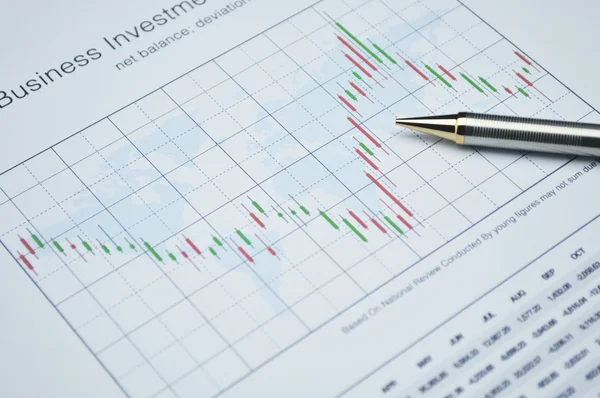 Pencil on stock market graph, financial concept — Stock Photo, Image