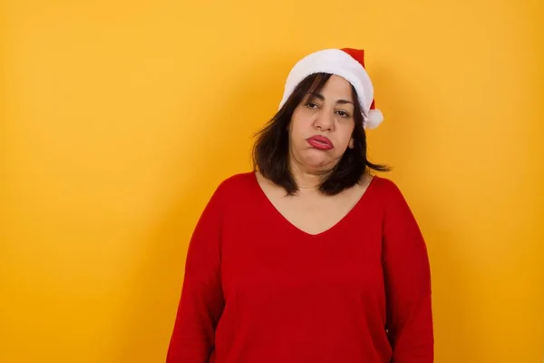 Gloomy Bored Arab Middle Aged Woman Wearing Christmas Hat Frowns — Stock Photo, Image