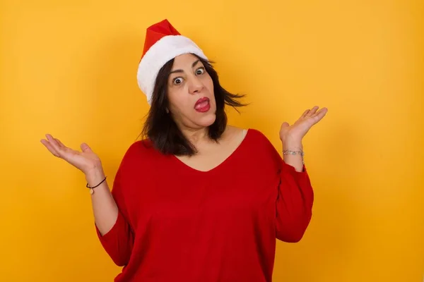 Beautiful Arab Middle Aged Woman Wearing Christmas Hat Doubt Expression — Stock Photo, Image