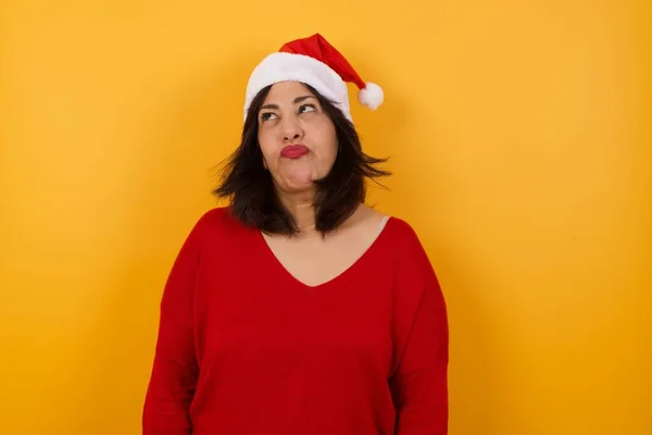 Gloomy Wondering Arab Middle Aged Woman Wearing Christmas Hat Looking — Stock Photo, Image