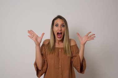 Neşeli kadın ellerini kaldırıyor, mutlulukla dolu gözleriyle büyük başarılarını kutluyor..