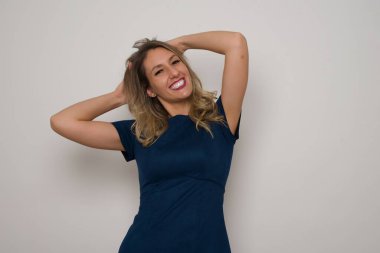 Güzel beyaz kadın poz veriyor. Gri arka planda duruyor. Reklam kavramı.