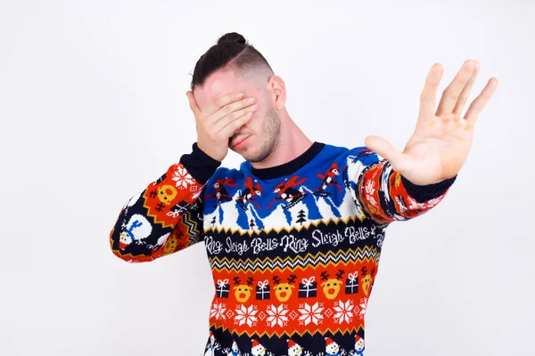 Caucasian Man Wearing Christmas Sweater White Wall Covers Eyes Palm — Stock Photo, Image