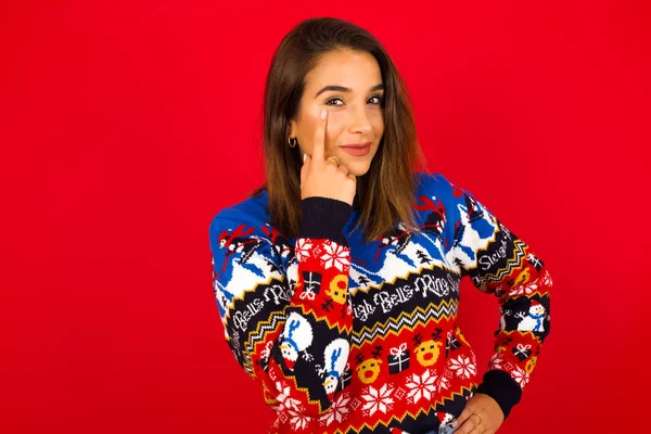 Mujer Caucásica Usando Suéter Navidad Contra Pared Roja Mirando Observando —  Fotos de Stock