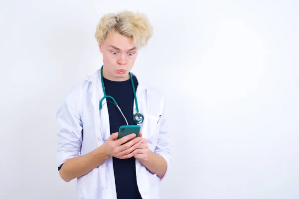 Caucasian Doctor Looks Bugged Eyes Holds Modern Smart Phone Receives — Stock Photo, Image