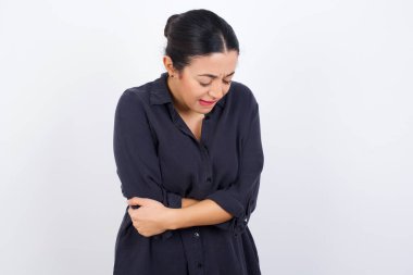  Genç ve güzel bir iş kadını, güçlü bir mide ağrısından muzdarip bir elbise giyiyor..