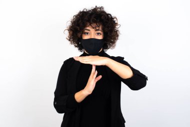  Tıbbi maske takan beyaz bir kadın yorgun ve sıkılmış hissediyor. Mola veriyor. İş stresi ve zaman kavramı yüzünden durması gerekiyor..
