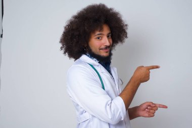 Çekici genç Afrikalı Amerikalı doktor, ağzı açık neşeli ve şaşkın bir ifadeyle içeride inanılmaz bir şey gösteriyor. Reklam kavramı.