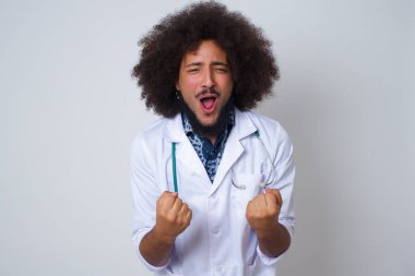 Güçlü ve kararlı genç Afrikalı Amerikalı doktor kazananın bel portresi. Günlük kıyafetlerini giymiş, kollarını kaldırmış, yumruklarını sıkmış, golü neşe ve heyecanla haykırıyor. Zafer, başarı ve başarı kavramı.