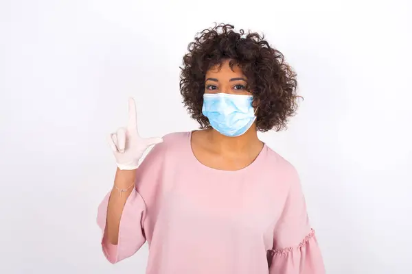 Jonge Vrouw Met Gezichtsmasker Wijst Naar Boven Geïsoleerd Witte Achtergrond — Stockfoto