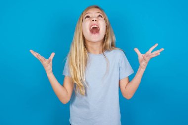 beautiful caucasian girl wearing t-shirt     crying and screaming. Human emotions, facial expression concept. Screaming, hate, rage. clipart