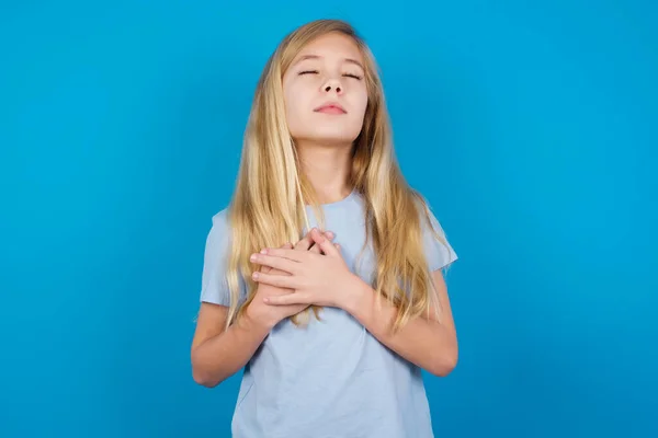 Beautiful Caucasian Girl Wearing Blue Shirt Closes Eyes Keeps Hands — Stock Photo, Image
