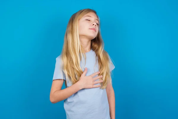 Satisfied Smiling Beautiful Caucasian Girl Wearing Blue Shirt Keeps Hands — Stock Photo, Image