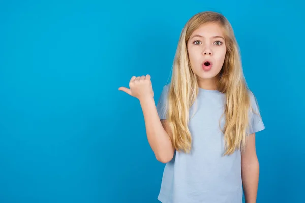 Shocked Beautiful Caucasian Girl Wearing Blue Shirt Points Thumb Away — Stock Photo, Image