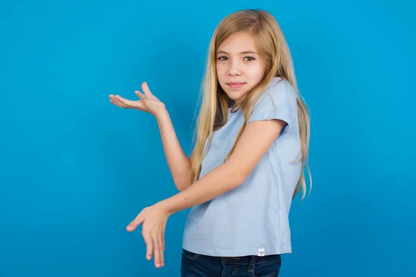 girl  pointing aside with both hands showing something strange and saying: I don\'t know what is this. Advertisement concept.