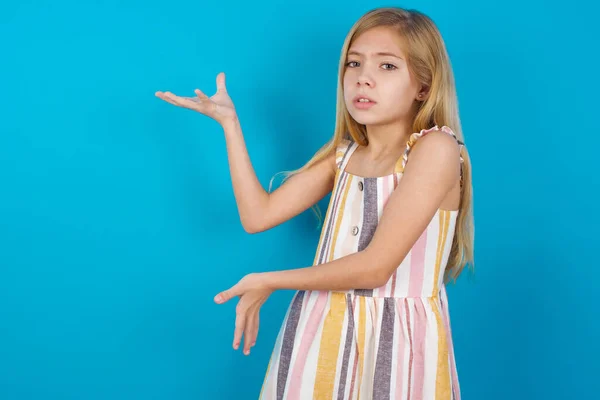 girl   pointing aside with both hands showing something strange and saying: I don\'t know what is this. Advertisement concept.