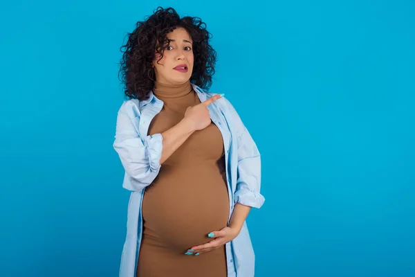 Kobieta Ciąży Arabski Wskazując Bok Zaniepokojony Nerwowy Palcem Wskazującym Zaniepokojenie — Zdjęcie stockowe