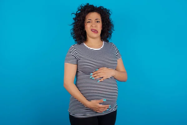 Portrait Dissatisfied Pregnant Arab Woman Wearing Striped Shirt Smirks Face — Stock Photo, Image