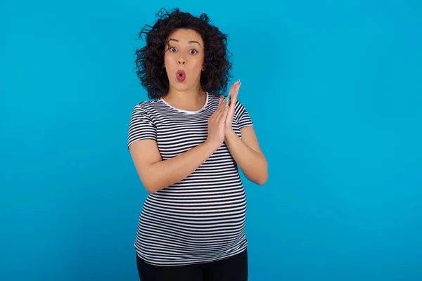 Surprised Emotional Pregnant Arab Woman Wearing Striped Shirt Rubs Palms — Stock Photo, Image