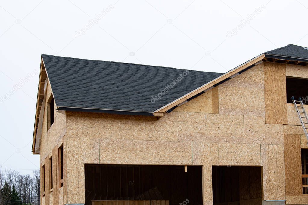 the roof of a plywood house shingles new