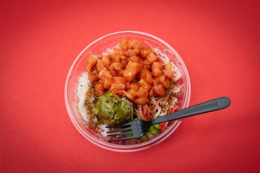 Tabakta pilav, avokado somonu ve balık.