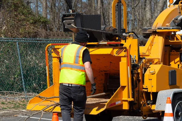 wood chipper machine releasing the shredded woods worker