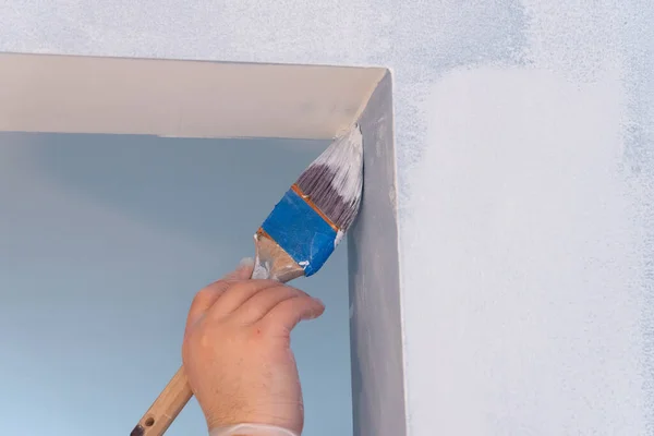 painting the wall with a brush home wall interior person