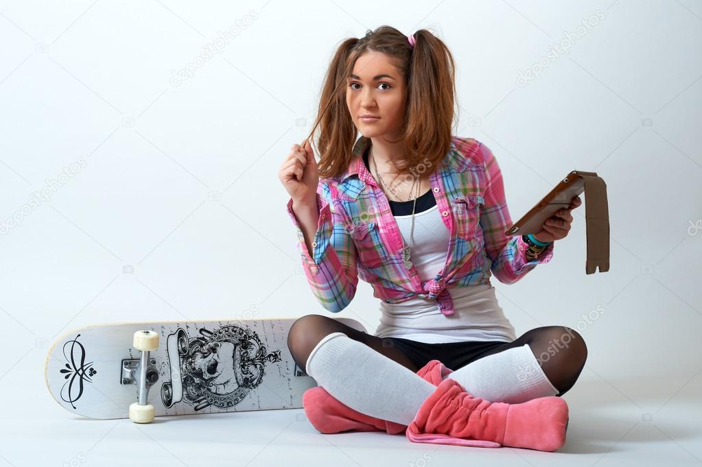 Young female sitting and holding tablet