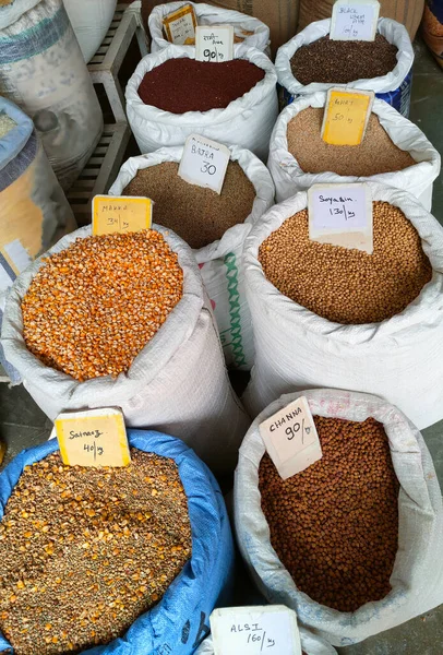 Bags of grains with price tags at a grocery shop