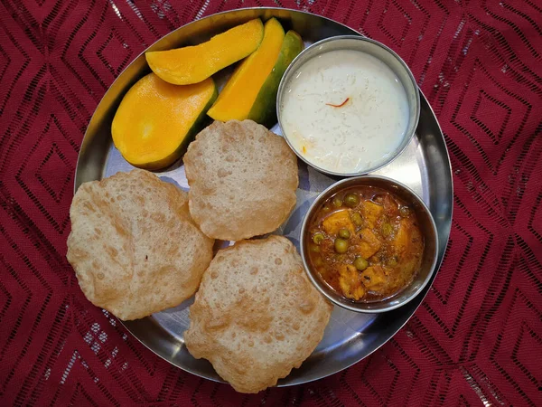 Indian traditional food with a mango fruit