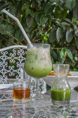 Buzlu cam masa üzerinde yeşil çay