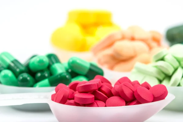 Pills in tea spoon on white background — Stock Photo, Image