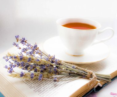 Lavender and a cup of tea on a book
