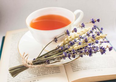 Lavender and a cup of tea on a book